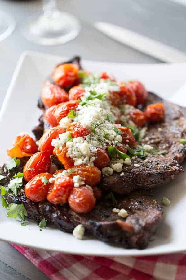 Simple grilled steak with roasted tomatoes and blue cheese. lemonsforlulu.com