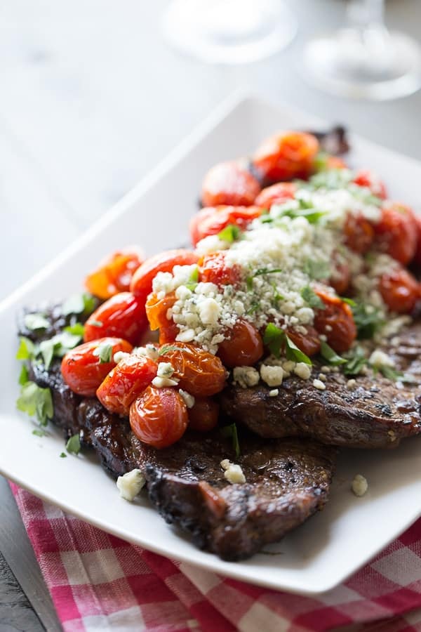 Perfectly grilled sirloin steak is covered in flavor-packed roasted tomatoes and blue cheese crumbles. lemonsforlulu.com