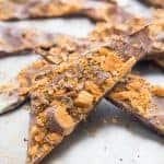 Chocolate bark candy make with white and semi sweet chocolate and lots of Butterfinger candies!