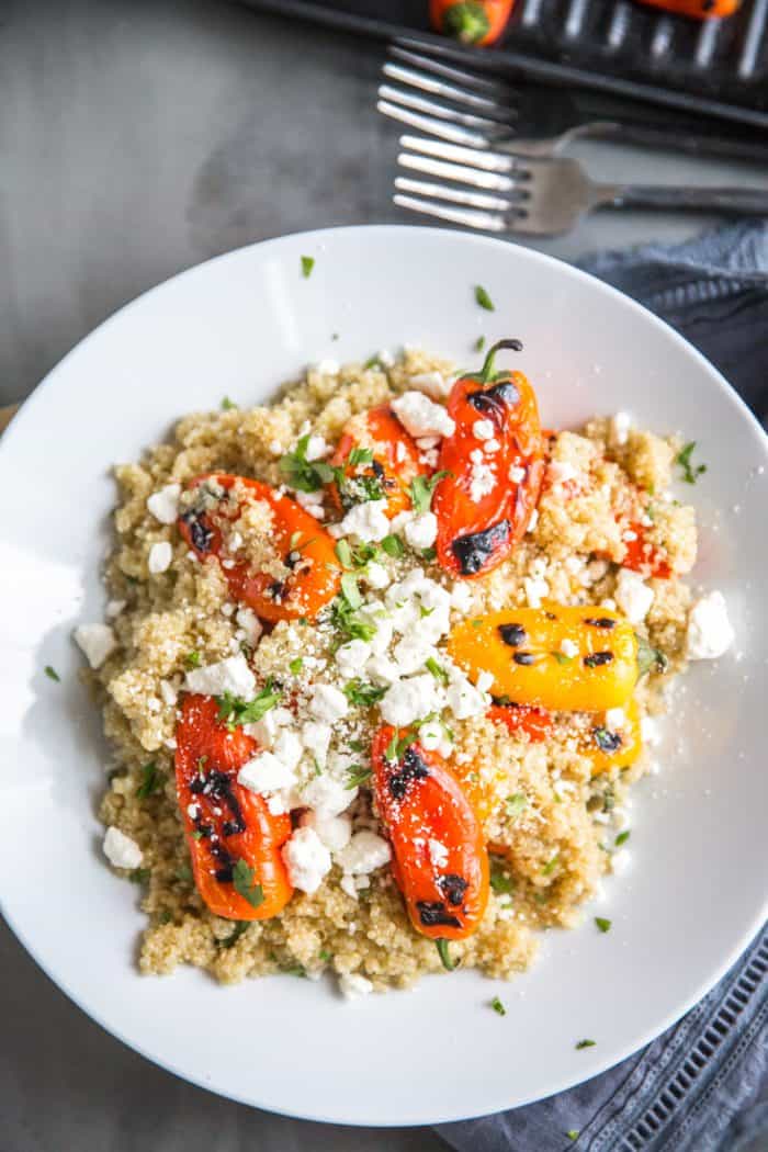 Quinoa with roasted peppers in a white bowl