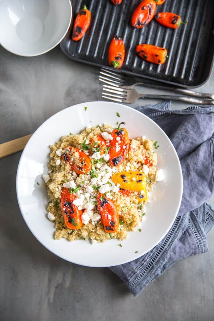 Quinoa and roasted peppers with peppers on a grill pn