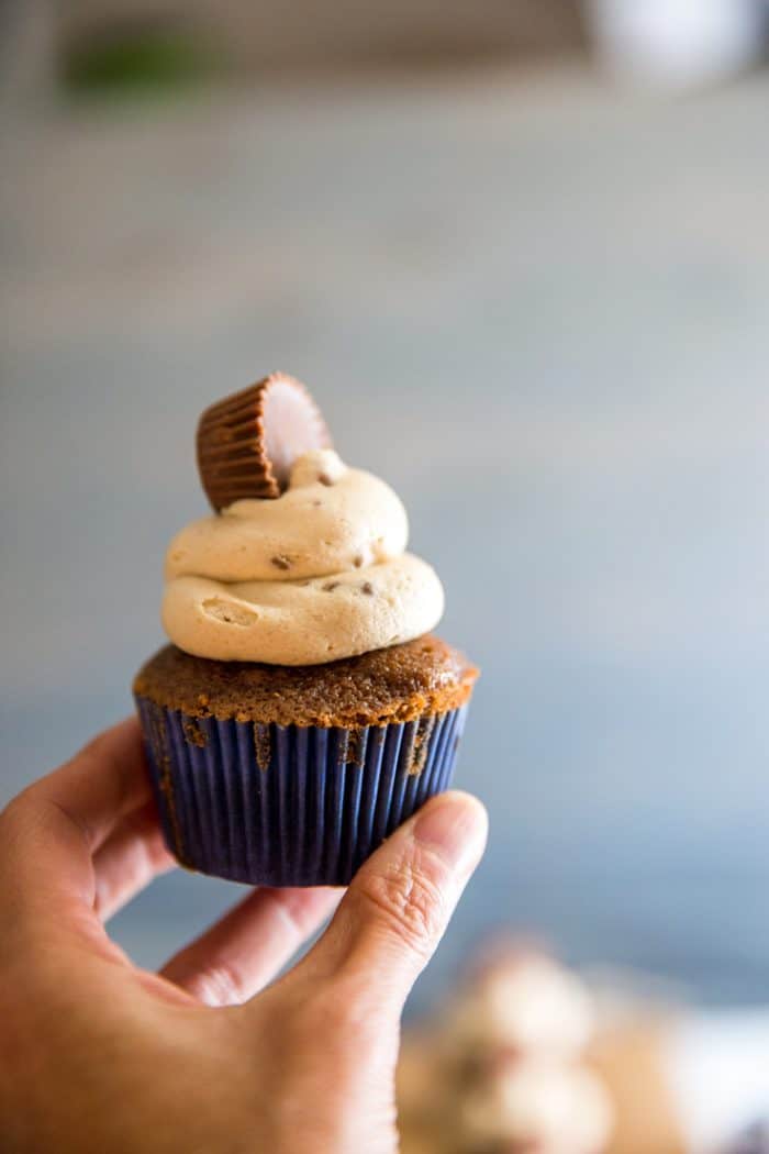 Held cupcake with peanut butter frosting