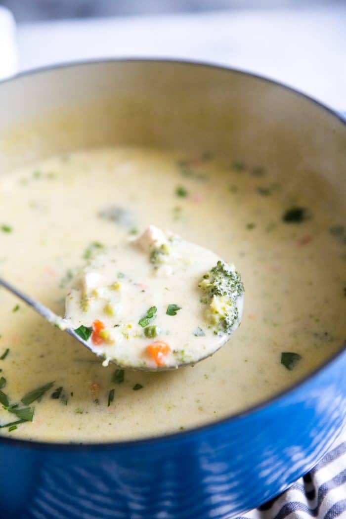 broccoli and cheddar soup with ladle
