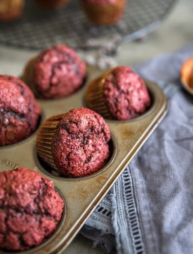red velvet chocolate chip muffins in a tin
