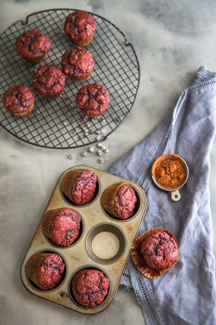 red velvet muffins in tin and on a rack
