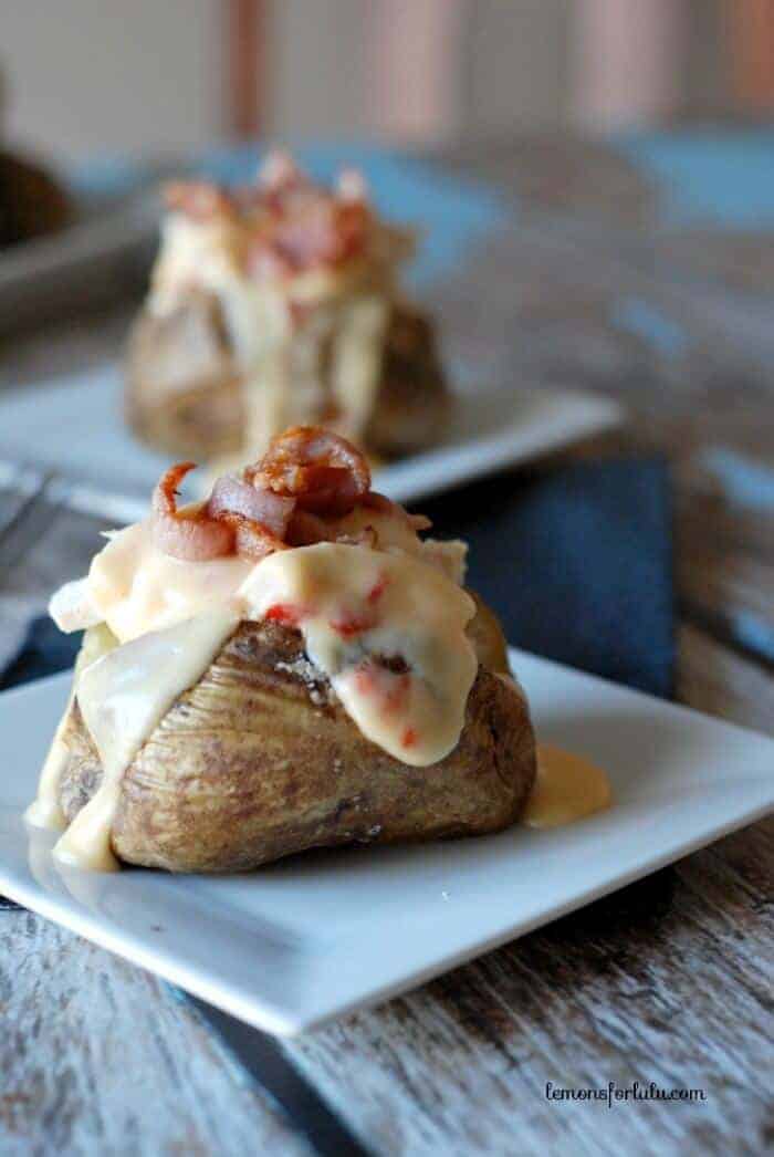 Hot Brown Baked Potato | lemonsforlulu.com, oven baked baked potato topped with chicken, a rich cheese sauce and crispy bacon!