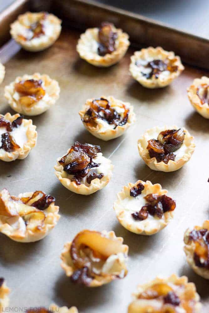 Baked brie cups topped with sweet caramelized onions, spicy nuts and a drizzle of honey! A simple, but pleaseing appetizer! www.lemonsforlulu.com #PantryInsider