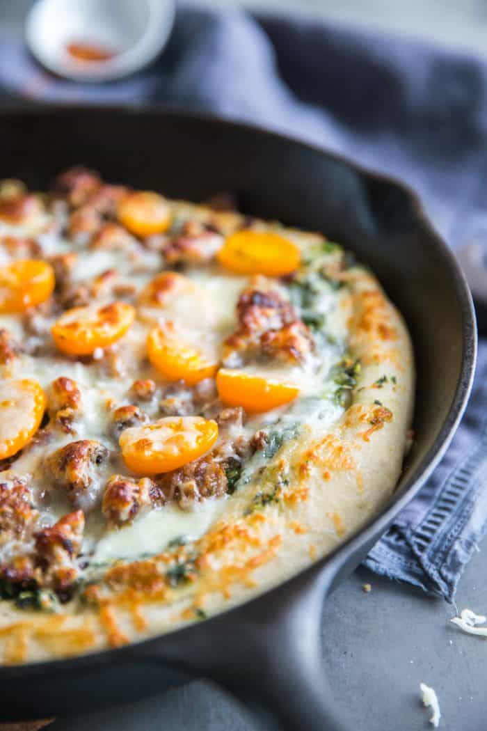 Sausage pizza with yellow tomatoes 