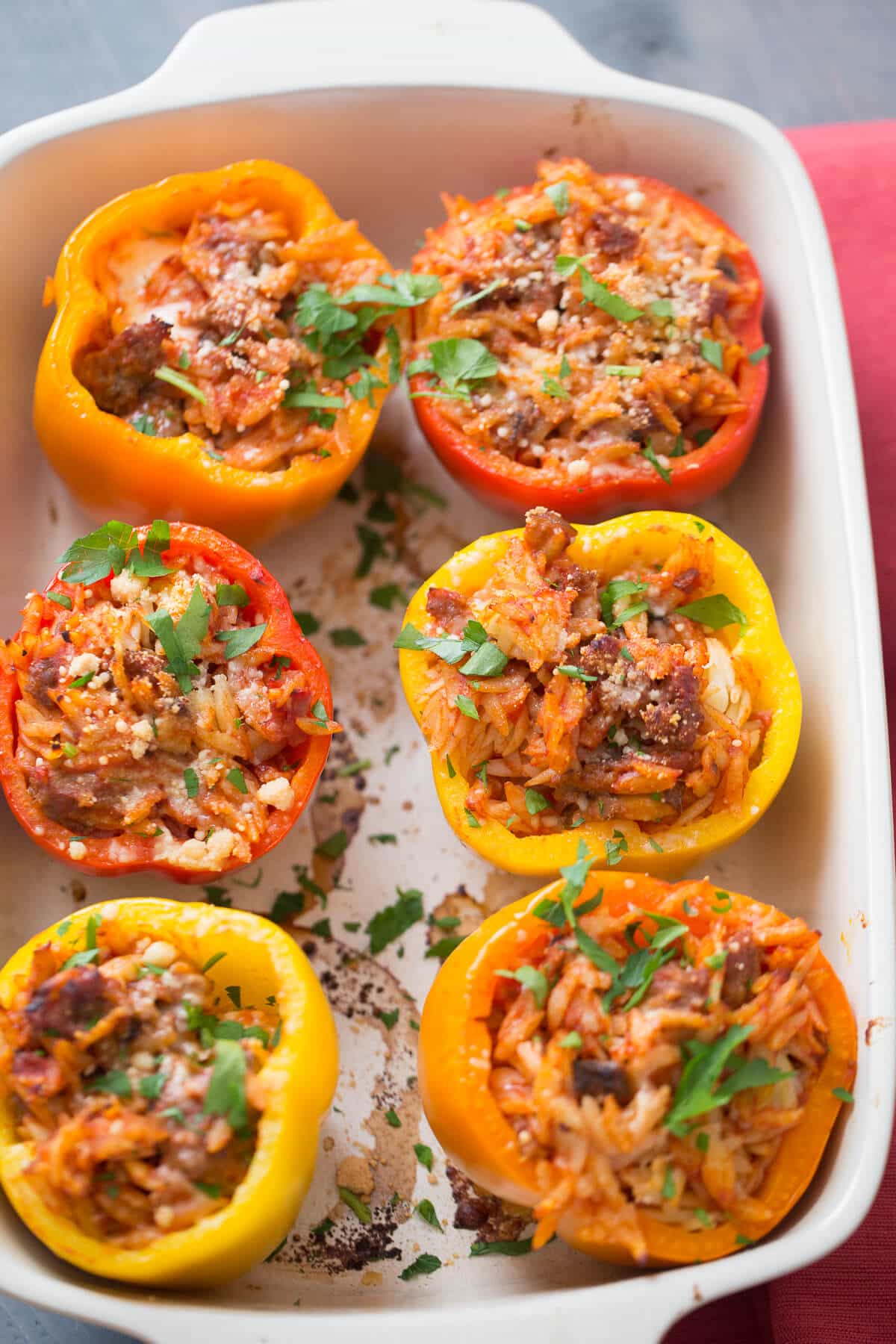 These Italian stuffed peppers are filled with sausage and orzo! Your family is going to love this tasty recipe!