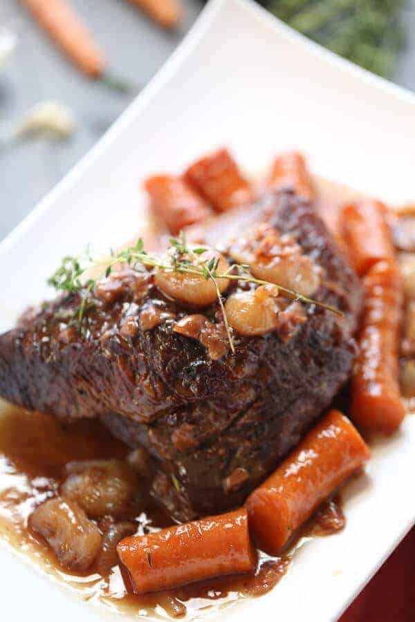 Braised beef brisket is slow cooked with vegetables and a perfect sweet and savory sauce: a perfectl dinner and it couldn’t be simpler! lemonsforlulu.com