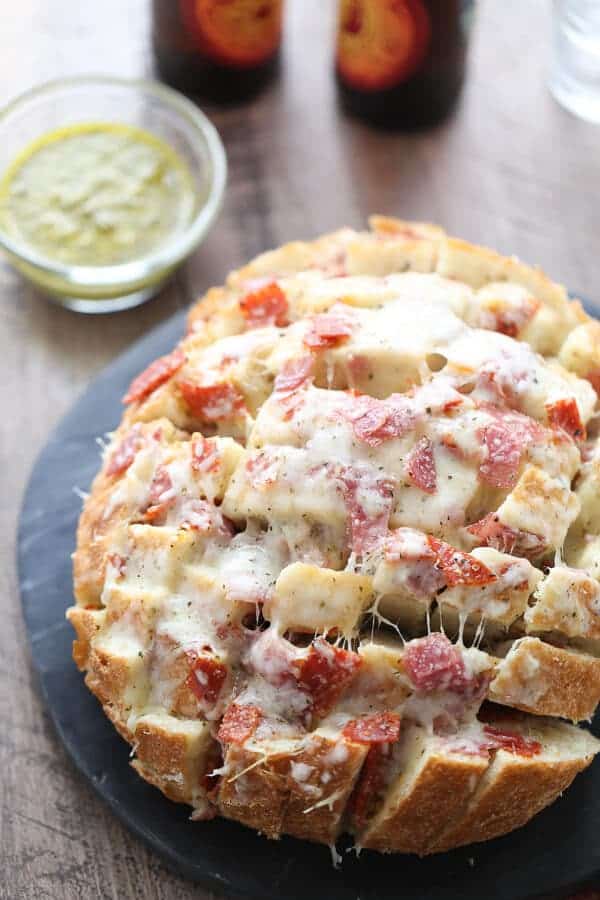 Crusty bread is stuffed full of cheese, and deli meats. This pull apart bread has everything you love about hoagies in one gooey, cheesy, appetizer! lemonsforlulu.com