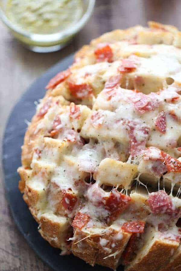 Crusty bread is stuffed full of cheese, and deli meats. This pull apart bread has everything you love about hoagies in one gooey, cheesy, appetizer! lemonsforlulu.com