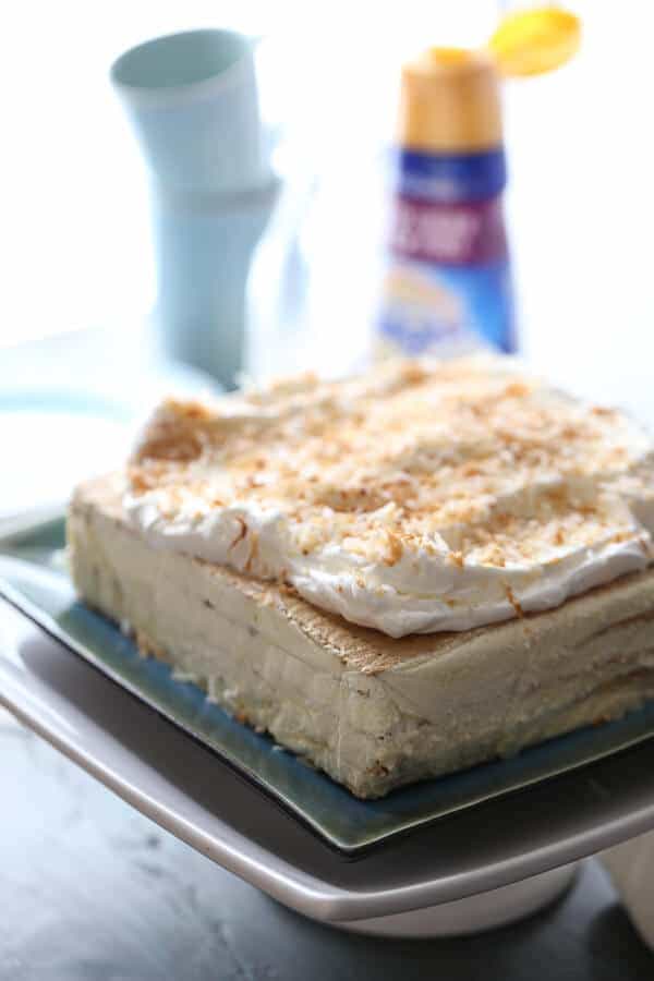 This vanilla coconut ice bake cake is such an easy no-bake treat! It’s rich and creamy too! lemonsforlulu.com #IDelight @InDelight