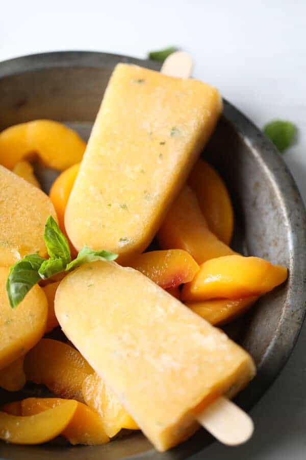Move over kiddos, these popsicles are for adults only! Lots of peaches, fresh basil and tequila make these margarita popsicles the perfect adult frozen treat! lemonsforlulu.com