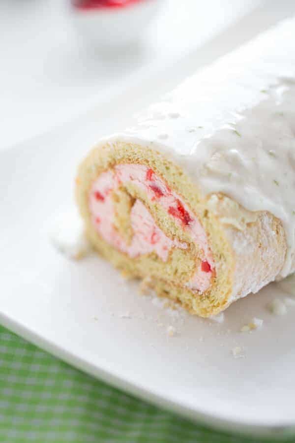 Roll cake with a sweet cherry buttercream filling and a tart lime glaze! lemonsforlulu.com