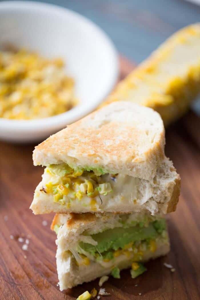 This grilled avocado and corn sandwich recipe captures the essence of summer! Fresh veggies and creamy cheese make this sandwich irresistible! lemonsforlulu.com