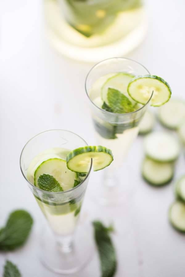 Cucumbers are not just for savory foods! This simple white sangria features lots of fresh cucumbers, cool mint and sweet melon! The perfect cocktail to keep you refreshed! lemonsforlulu.com