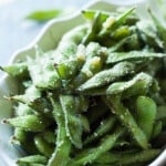 Edamame is steamed then coated in olive oil, garlic and Parmesan Cheese! Enjoy these pods as a side or even as a snack! lemonsforlulu.com
