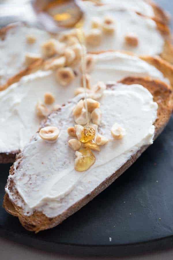 This simple elegant goat cheese appetizer is rich, tangy, sweet and delicious! The crunchy hazelnuts takes it to a whole new level! lemonsforlulu.com