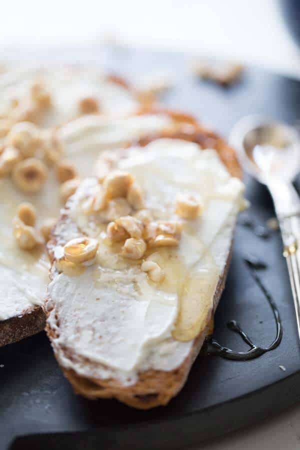 A creamy goat cheese appetizer drizzled with sweet honey and crunchy hazelnuts! lemonsforlulu.com