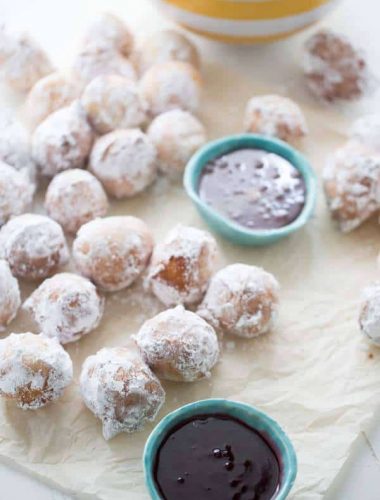 This ricotta donuts recipes is a sweet lovers dream! Tender little donuts are lightly fried then covered in powdered sugar. Serve these bundles with both raspberry and caramel dipping sauce! lemonsforlulu.com