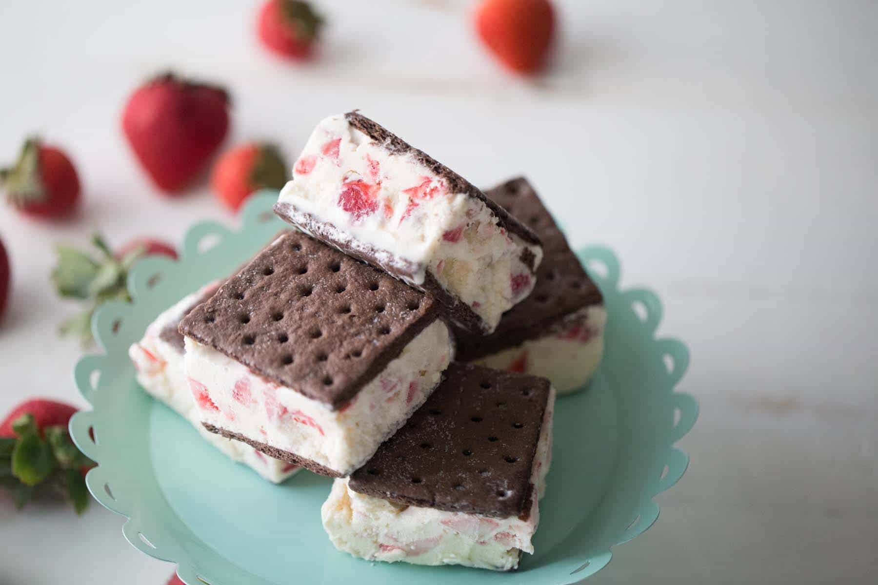 Strawberries and cream come together in this fun dessert recipe! These fun strawberry ice cream sanwiches will please everyone! lemonsforlulu.com
