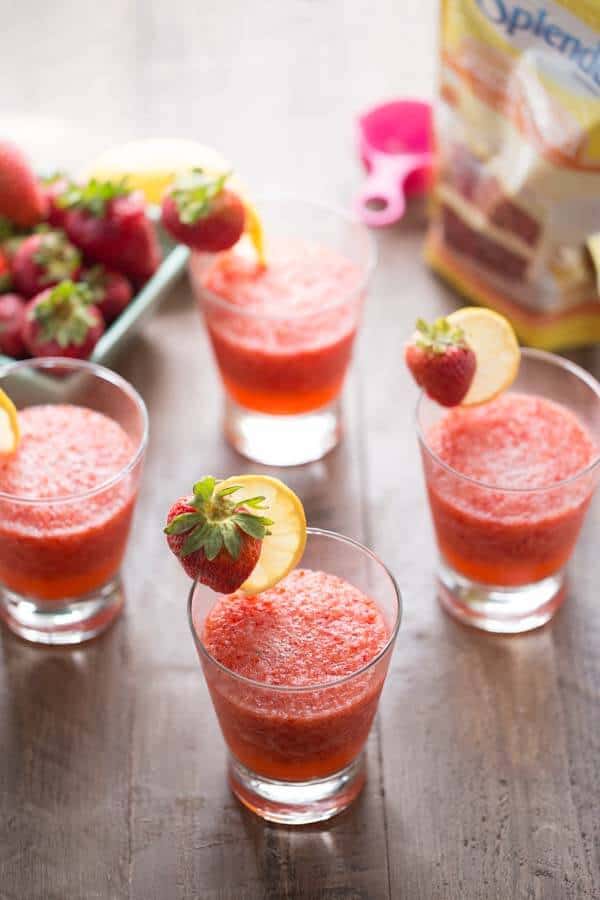 Four simple strawberry rickey mocktails with refreshing strawberries next to a package of Splenda on a wooden table.