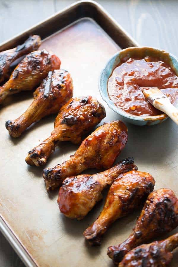 Grilled chicken drumsticks are covered in a spicy sweet chili garlic bbq sauce. lemonsforlulu.com