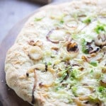 Homemade pizza dough is quicky and easy! This pizza is topped simply with caramelized onions, fontina cheese and Brussels sprouts! lemonsforlulu.com
