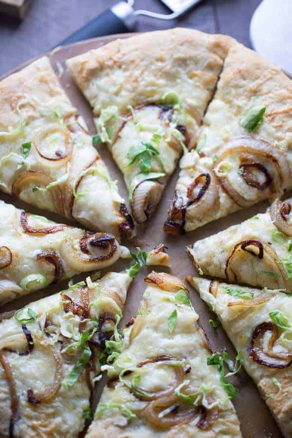 Easy homemade pizza topped with caramelized onions and Brussels sprouts! lemonsforlulu.com