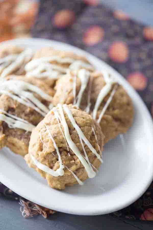 Perfect and soft pumpkin cookies with loads of toffee bits and topped with just a drizzle of white chocolate! lemonsforlulu.com