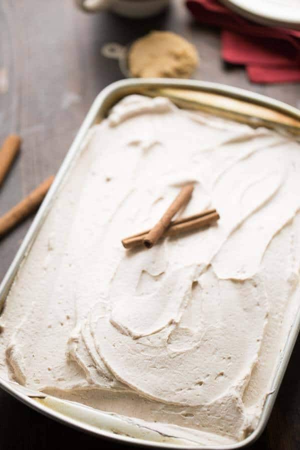 Snickerdoodle poke cake is filled with brown sugar and cinnamon and topped with the creamiest frosting ever! lemonsforlulu.com