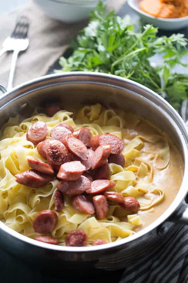 Spiced pumpkin pasta with smoked sausage is so creamy and flavorful, you’ll be going back for seconds! lemonsforlulu.com