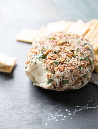 This easy cheese ball is crazy good! Roasted garlic and three kinds of cheese make this creamy appetizer positively addicting! lemonsforlulu.com