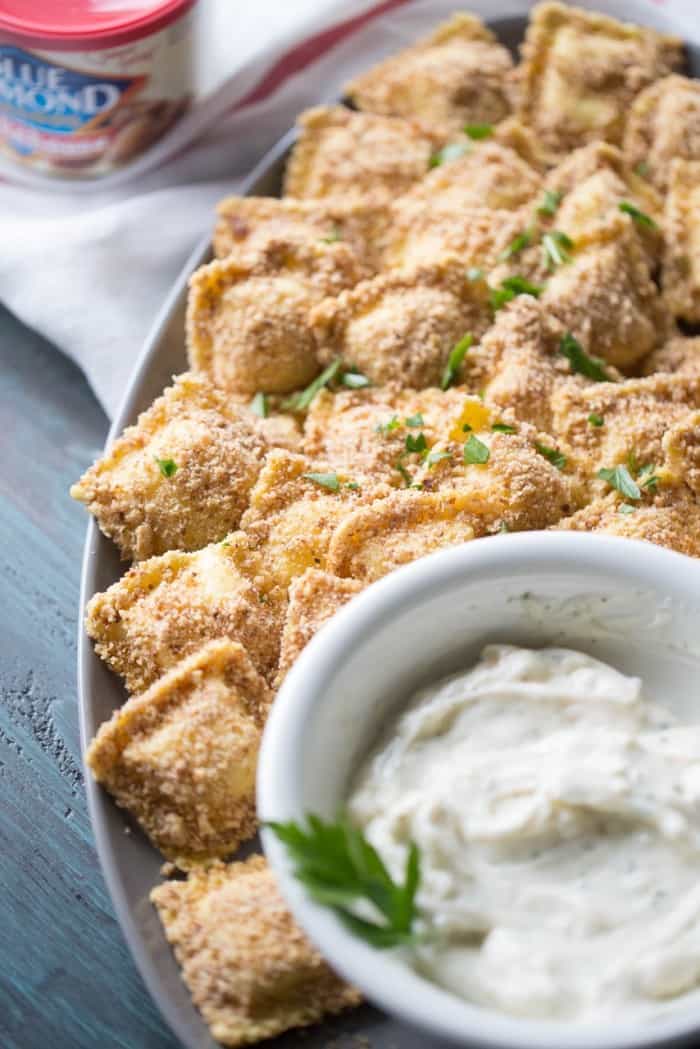 Almond crusted toasted ravioli is a light spin a favorite appetizer! The almonds bring a smokey bbq flavor to the crust which is why the white bbq sauce has to be served on the side! lemonsforlulu.com