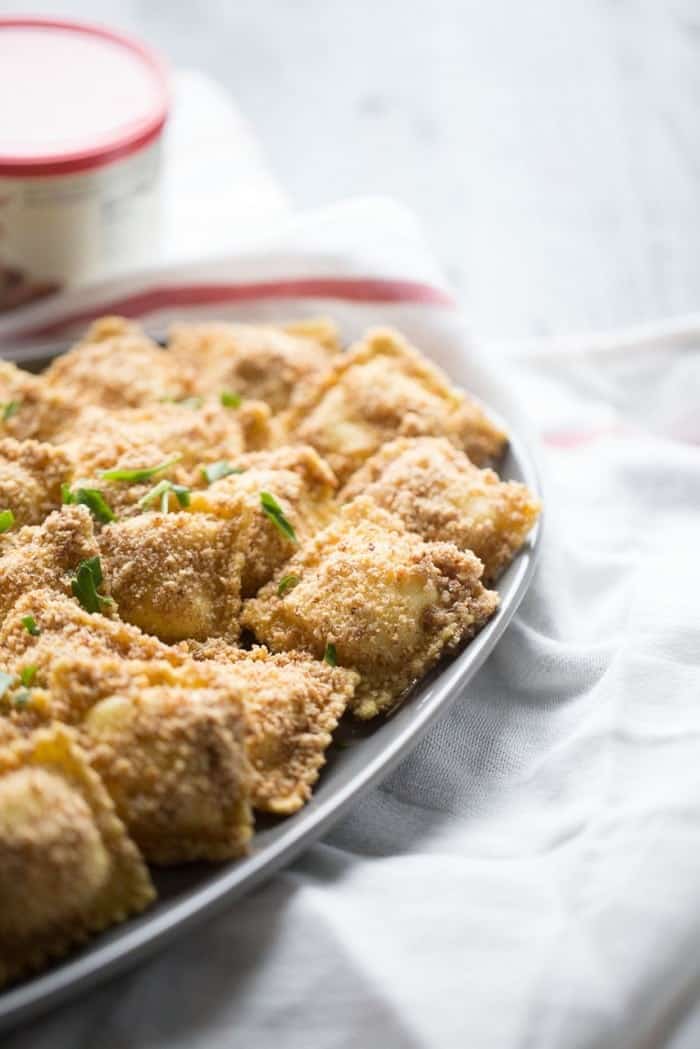 This baked breaded ravioli is a nice change from your typical fried appetizer! The ranch flavored white bbq sauce is the perfect dip for the smokey almond crust! lemonsforlulu.com