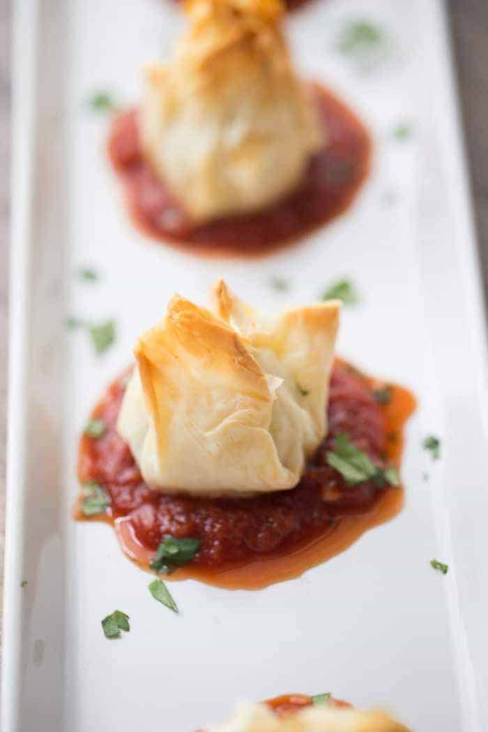 Chicken Parmesan meatballs wrapped in flaky sheets of fillo dough! lemonsforlulu.com