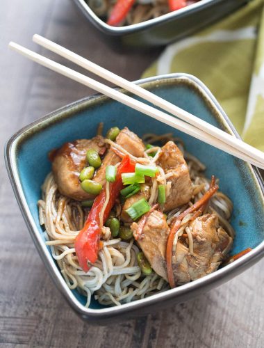 Blue bowl of Chicken Teriyaki with Noodles with wooden chopsticks.