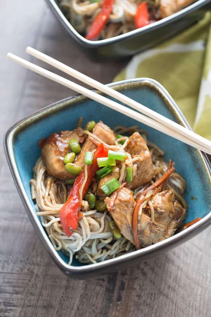 Blue bowl of Chicken Teriyaki with Noodles with wooden chopsticks.
