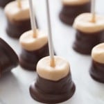 Marshmallow pops that are dipped in a mixture of white chocolate and peanut butter then semi sweet chocolate! Like a buckeye candy but oh so easy! lemonsforlulu.com