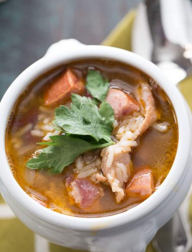 Red beans and rice are mixed with bacon and andouille sausage for flavorful and filling soup recipe! lemonsforlulu.com
