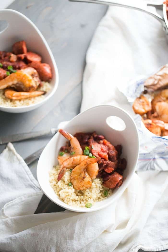 Cajun shrimp quickly baked in the oven and served atop a bed of quinoa, sausage and red beans! lemonsforlulu.com