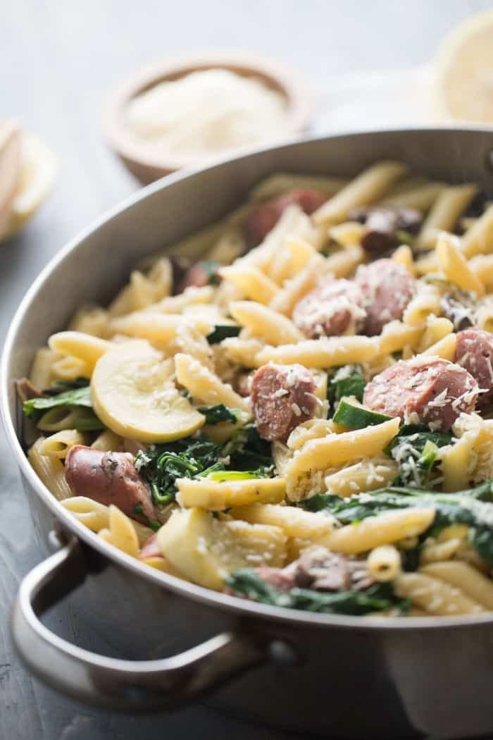 A simple penne pasta recipe made with chicken sausage and loads of fresh veggies! lemonsforlulu.com
