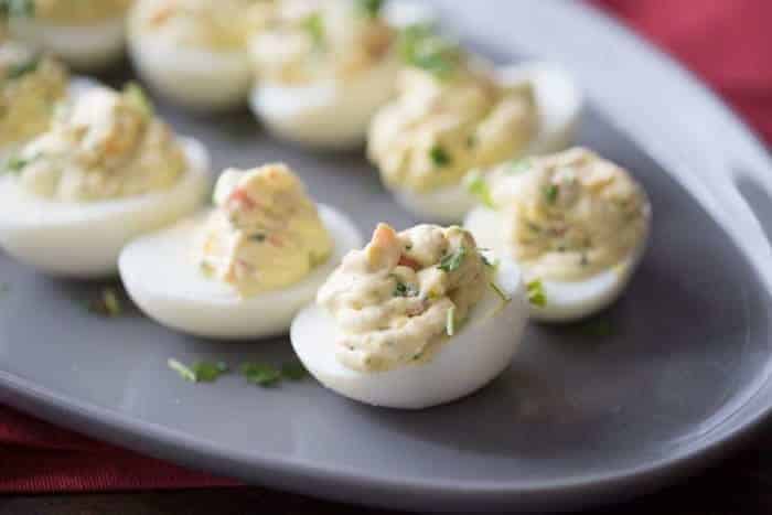 A simple deviled egg recipe with ranch seasoning and fresh garden veggies!