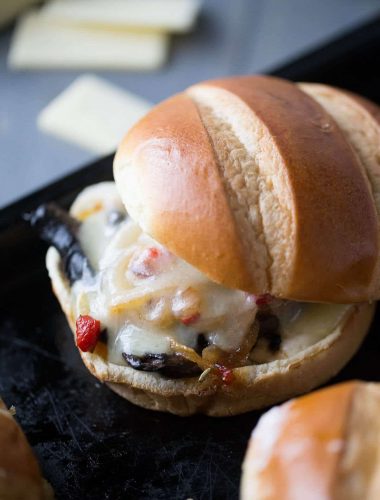 This veggie sandwich is filled with meaty portobello mushrooms and pepper. Tangy white cheddar cheese is melted on top to hold it all together!