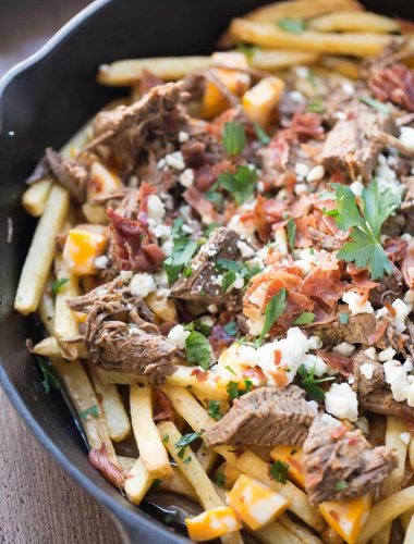 This easy poutine recipe has slow cooked brisket, bacon and two kinds of cheese !