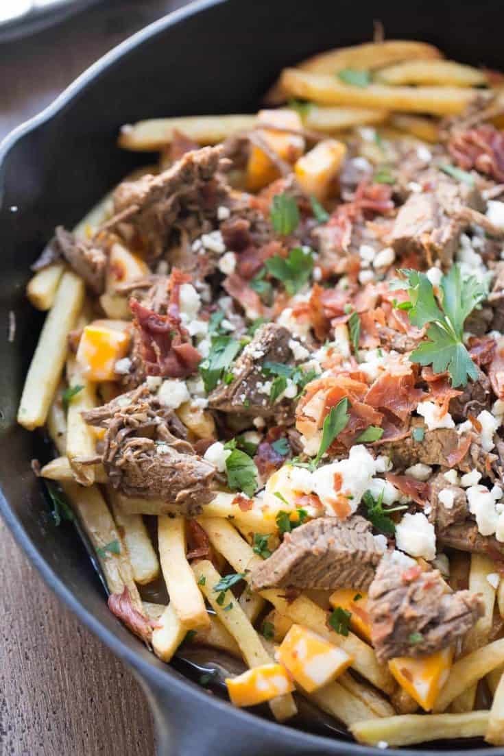 This easy poutine recipe has slow cooked brisket, bacon and two kinds of cheese !