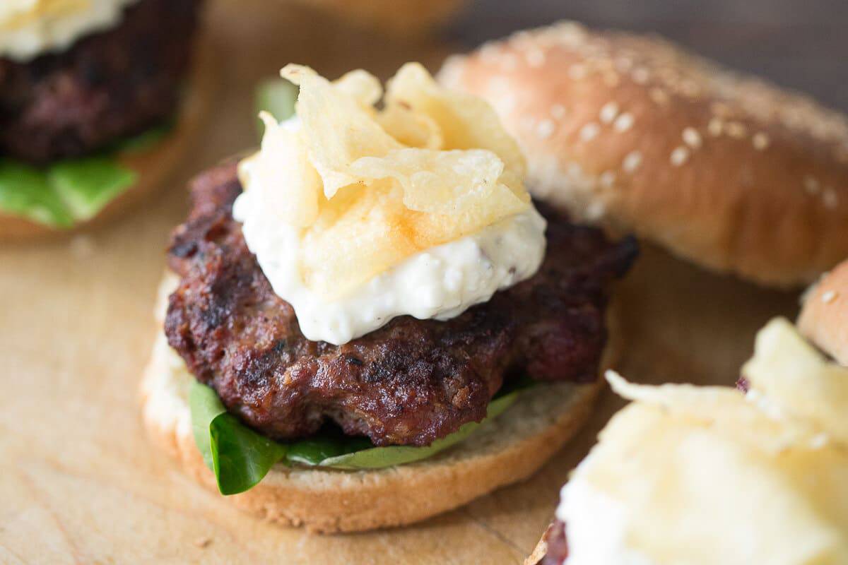 These black and blue burger is thick and juicy and holds so many unexpected flavors. Spicy seasoning, creamy remoulade and crunchy chips make this burger outstanding!