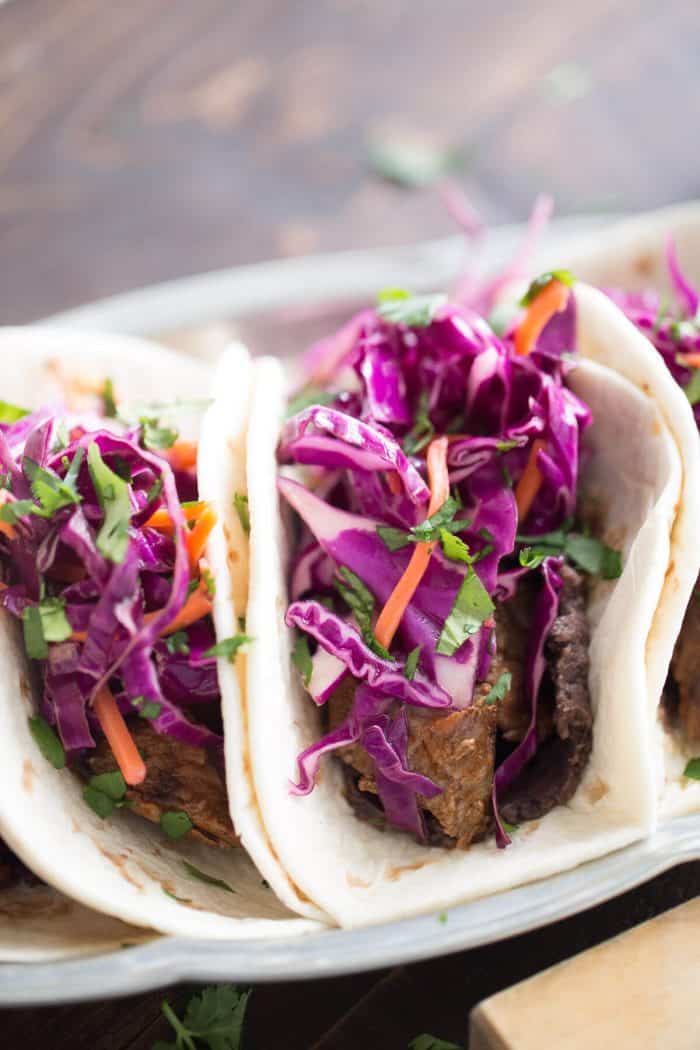 Grilled steak is seasoned with a smoky rub then combined with a garlic bean mixture and a honey lime coleslaw! East and west collide in each bite!