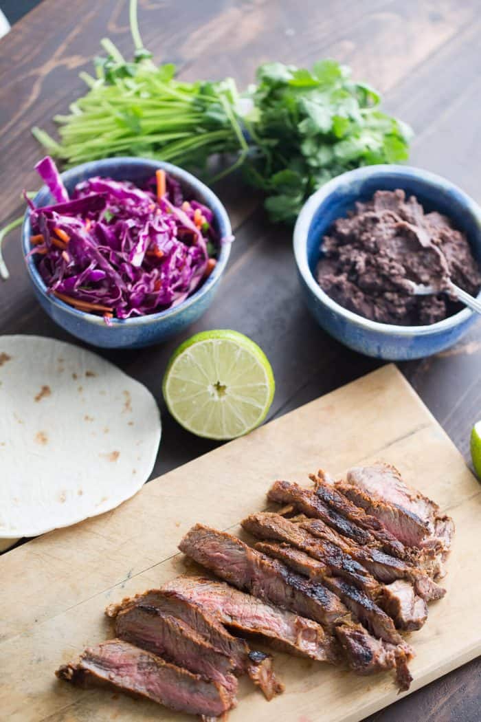 Grilled steak is seasoned with a smoky rub then combined with a garlic bean mixture and a honey lime coleslaw! East and west collide in each bite!